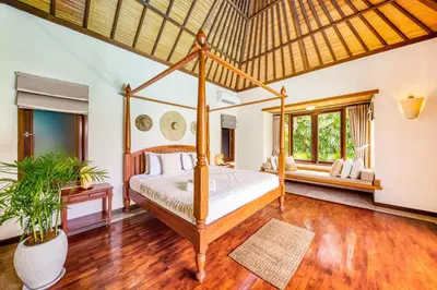 a bedroom with a four poster bed in a room at Villa Jalamati in Seminyak