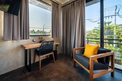 a room with a desk and chairs and a window at ZenBali 1 Villa Canggu in Canggu