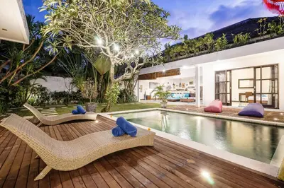 a villa with a swimming pool and a house at Villa Art Gecko, 2BR private haven in Heart of Batu Belig, Seminyak in Canggu