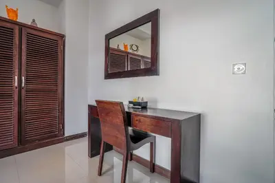 a desk with a chair and a mirror on a wall at Villa Art Gecko, 2BR private haven in Heart of Batu Belig, Seminyak in Canggu