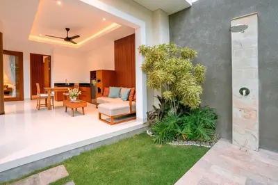 an open patio with a table and a chair at Kahayana Seminyak Villa in Seminyak