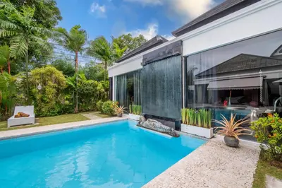 an image of a swimming pool in front of a house at Villa Kalamansi Seminyak in Seminyak