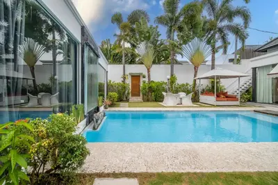 a swimming pool in the backyard of a house at Villa Kalamansi Seminyak in Seminyak