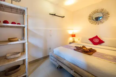 a bedroom with a bunk bed and a mirror at Villa Kalamansi Seminyak in Seminyak