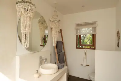 a bathroom with a sink and a mirror at Villa Folie by Alfred in Bali in Seminyak
