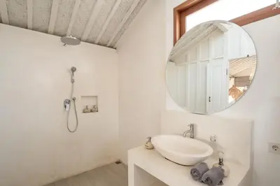 a bathroom with a sink and a mirror at Villa Folie by Alfred in Bali in Seminyak
