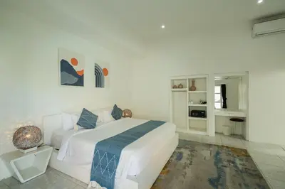 a white bedroom with a white bed and a couch at Modern 3 Bedrooms Villa Beach Walking Distance in Seminyak