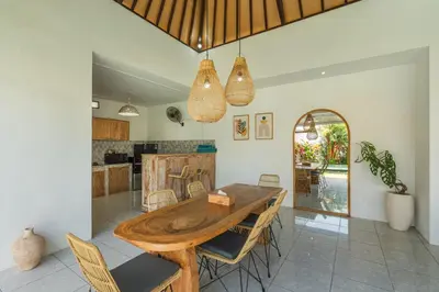 a kitchen and dining room with a wooden table and chairs at Modern 3 Bedrooms Villa Beach Walking Distance in Seminyak