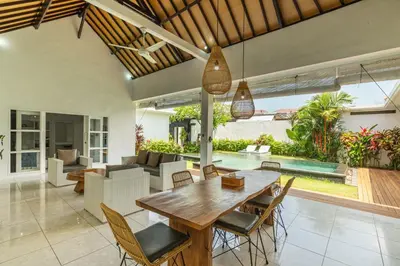 an open living room with a wooden table and chairs at Modern 3 Bedrooms Villa Beach Walking Distance in Seminyak