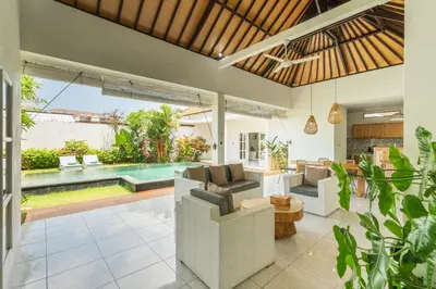 an open living room with a pool in the background at Modern 3 Bedrooms Villa Beach Walking Distance in Seminyak