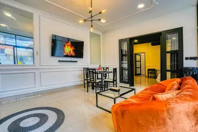 a living room with an orange couch and a table at Villa Canberra - Seminyak in Seminyak