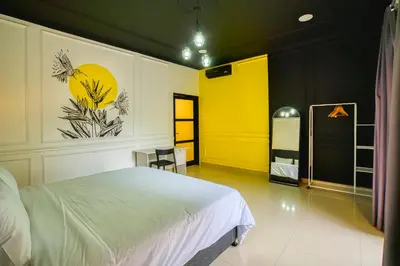 a bedroom with a white bed and a yellow door at Villa Canberra - Seminyak in Seminyak