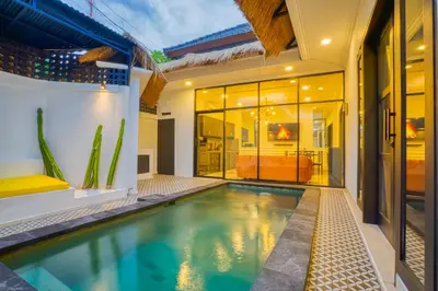 a swimming pool in the middle of a house at Villa Canberra - Seminyak in Seminyak