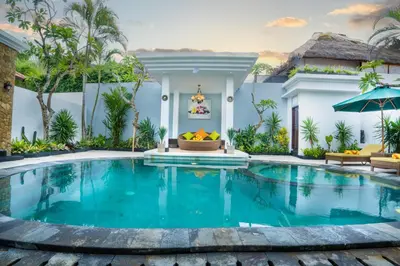 a swimming pool in front of a villa at Alam Jepun Villa in Legian