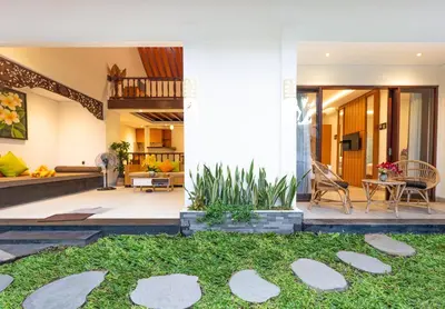 a house with a courtyard and a living room at Alam Jepun Villa in Legian