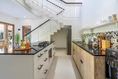 a large kitchen with a staircase in a house at NEW Villa Indah Seminyak 3BR Private Pool in Seminyak