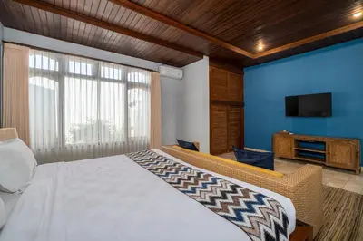 a bedroom with a bed and a flat screen tv at Villa Kori Bali Kubu, 9 people maximum, close to Seminyak Beach in Seminyak