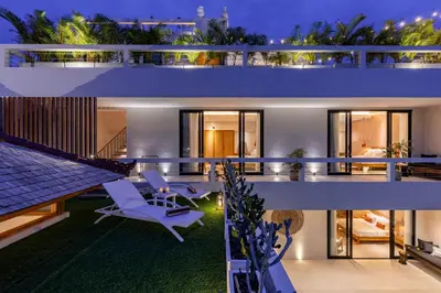 a house with a view of the backyard at night at Premium 5 bd Luxury Central Villa 300m to beach & Ku De Ta in Seminyak