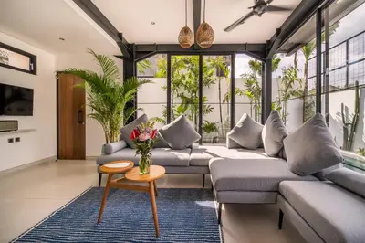 a living room with couches and a table at Villa Vantage Canggu in Canggu