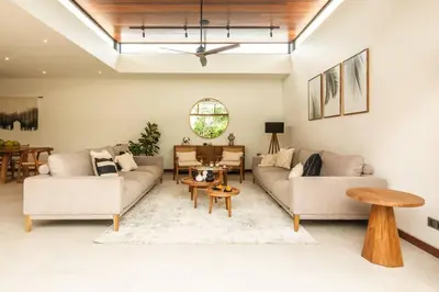 a living room with two couches and a table at Luxury 5bd Villa 5 Min From Berawa Beach in Canggu