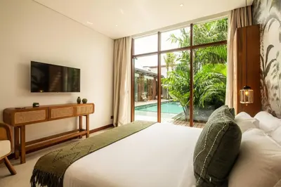 a bedroom with a bed and a large window at Luxury 5bd Villa 5 Min From Berawa Beach in Canggu