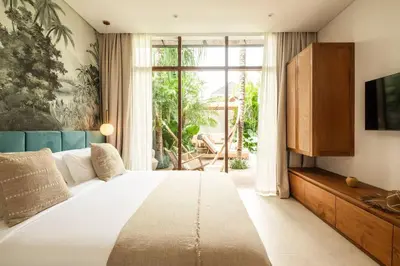 a bedroom with a large bed and a large window at Luxury 5bd Villa 5 Min From Berawa Beach in Canggu