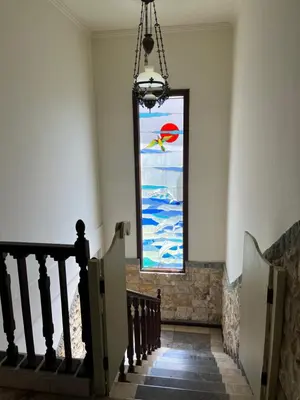 a stairway with a stained glass window in a building at Largest Villa in Kuta Royal C1 - Turquoise Villa in Kuta