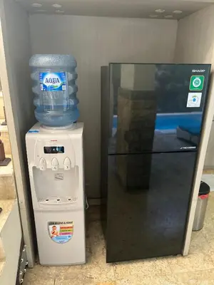 a refrigerator with a gallon of water on top of it at Largest Villa in Kuta Royal C1 - Turquoise Villa in Kuta