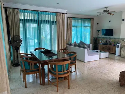a living room with a table and chairs and a couch at Largest Villa in Kuta Royal C1 - Turquoise Villa in Kuta