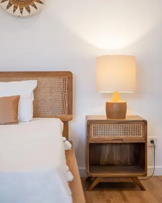 a bedroom with a bed and a lamp on a night stand at Villa Seminyak - 2bdr private big pool villa in Seminyak