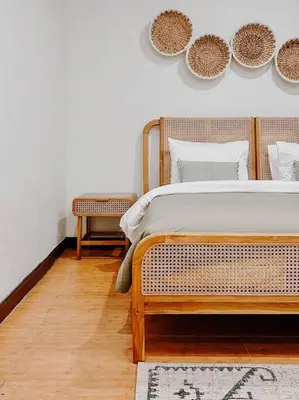 a bedroom with a bed and a wall with plates at Villa Sriwedari - Seminyak in Seminyak