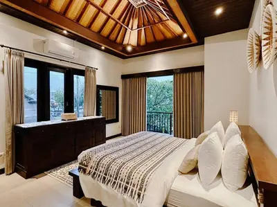 a bedroom with a large bed and a large window at Villa Sriwedari - Seminyak in Seminyak