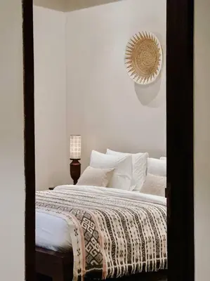 a bedroom with a large bed with white pillows at Villa Sriwedari - Seminyak in Seminyak