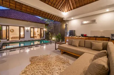 a living room with a couch and a swimming pool at [Seminyak central] private 3 bedrooms villa with swimming pool in Seminyak