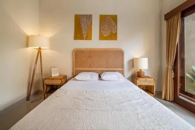 a bedroom with a large bed with two night stands at [Seminyak central] private 3 bedrooms villa with swimming pool in Seminyak