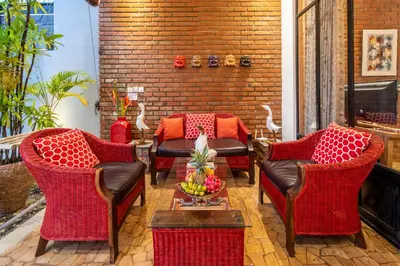 a patio with chairs and a table with fruit on it at Villa Lollie Seminyak in Seminyak