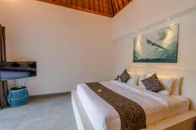 a bedroom with a large bed and a tv at Villa Becca Seminyak by Best Deals Asia Hospitality in Seminyak