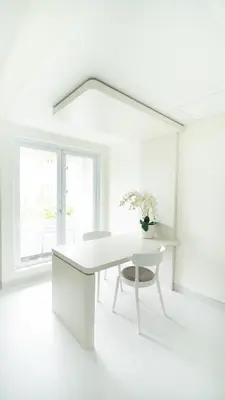 a white office with a white desk and a chair at The Axara Bali Managed by ARM Hospitality in Nusa Dua