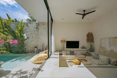a living room with a couch and a tv at Casa Noema in Kerobokan