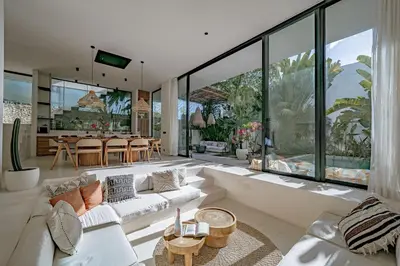 a living room with a couch and a table at Casa Noema in Kerobokan