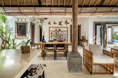 a dining room with a table and chairs at Rumah Ananda Bali - Balinese Villa Umalas in Canggu