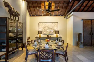 a dining room with a table and chairs and a ceiling fan at Villa De Suma - Fully Staffed Luxury Villa, Central Seminyak, walk to the beach in Seminyak
