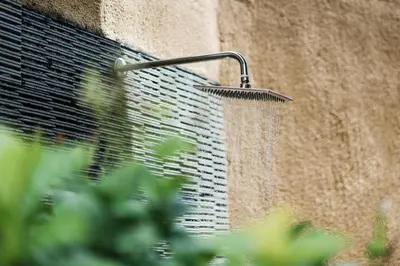 a shower built into the side of a building at Bali Radiance Villas Seminyak in Seminyak