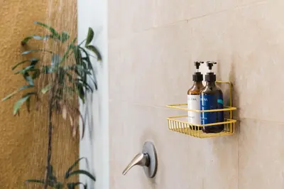 a bathroom with a soap dispenser on a wall at Bali Radiance Villas Seminyak in Seminyak