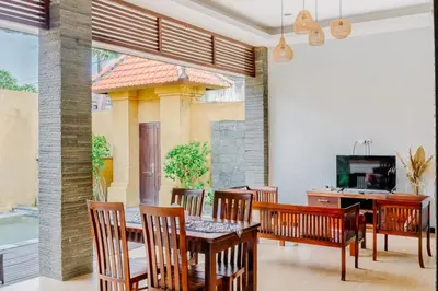 a dining room with a table and chairs at Bali Radiance Villas Seminyak in Seminyak