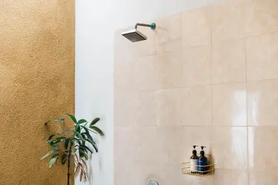 a bathroom with a shower with a shower head at Bali Radiance Villas Seminyak in Seminyak