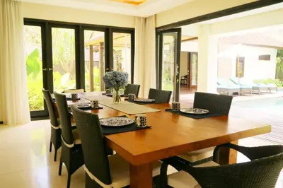 a dining room with a wooden table and chairs at Villa Mertasari 10C 4 Bedroom with Swimming pool! in Sanur