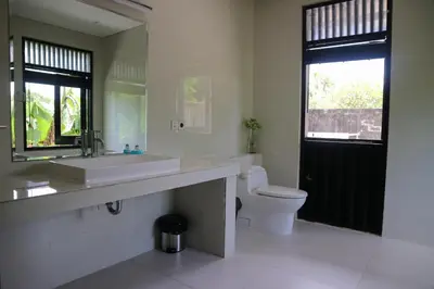 a bathroom with a sink and a toilet and a window at Villa Mertasari 10C 4 Bedroom with Swimming pool! in Sanur