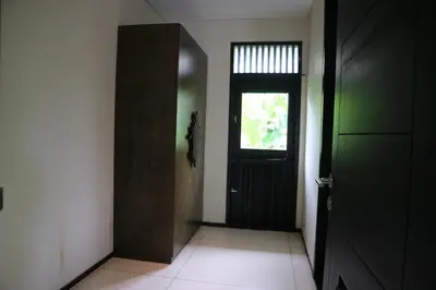 a hallway with a black door and a window at Villa Mertasari 10C 4 Bedroom with Swimming pool! in Sanur