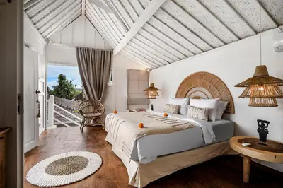 a bedroom with a large bed and a balcony at Villa Cyma by Alfred in Bali in Seminyak